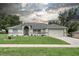 Well-maintained single-Gathering home featuring a manicured lawn and neutral exterior at 1132 Hill Mount Dr, Minneola, FL 34715
