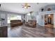 Bright, open living room with vaulted ceilings, hardwood floors, and two comfortable sofas at 1132 Hill Mount Dr, Minneola, FL 34715