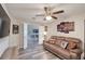 A cozy living room offers a comfortable couch and wood-look laminate flooring at 1132 Hill Mount Dr, Minneola, FL 34715
