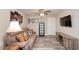The living room offers a cozy couch, TV, and wood-look laminate flooring at 1132 Hill Mount Dr, Minneola, FL 34715