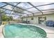 Inviting in-ground pool with a screened enclosure and ample patio space for relaxation at 1132 Hill Mount Dr, Minneola, FL 34715