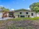 Charming backyard featuring an outdoor bar and a well-maintained lawn at 1156 Capella Dr, Tavares, FL 32778