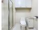 Bright bathroom with a glass enclosed shower, toilet, built in shelving and storage cabinet at 1156 Capella Dr, Tavares, FL 32778