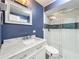 Chic bathroom with marble vanity, modern sink, framed mirror, and glass-enclosed shower at 1156 Capella Dr, Tavares, FL 32778