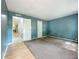 Spacious bedroom featuring plush carpeting and a doorway leading to another room with wood flooring at 1156 Capella Dr, Tavares, FL 32778