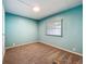 Inviting bedroom with soft carpeting, light teal walls, and a window with blinds at 1156 Capella Dr, Tavares, FL 32778