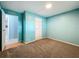 Comfortable bedroom featuring soft carpeting, an open doorway and a white closet door at 1156 Capella Dr, Tavares, FL 32778