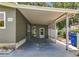 Spacious carport providing covered parking and access to a side entry door, offering convenience and protection from the elements at 1156 Capella Dr, Tavares, FL 32778