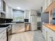 Modern kitchen featuring white cabinets, stainless steel appliances, sleek countertops, and stylish backsplash, perfect for culinary enthusiasts at 1156 Capella Dr, Tavares, FL 32778