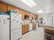 Well-equipped kitchen featuring wooden cabinets, white appliances, and ample counter space at 1156 Capella Dr, Tavares, FL 32778