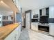 Beautiful kitchen showcasing white cabinets, modern appliances, a convenient pantry, and stylish countertops, ideal for cooking and entertaining at 1156 Capella Dr, Tavares, FL 32778