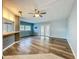 Spacious living room featuring wood-look floors, a ceiling fan, and natural light, creating an inviting atmosphere for relaxation at 1156 Capella Dr, Tavares, FL 32778