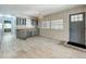 Inviting living room featuring gray cabinets, modern lighting, and large windows at 1156 Capella Dr, Tavares, FL 32778