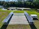 Community shuffleboard courts with picnic tables and lake views provide a relaxing recreational space at 1156 Capella Dr, Tavares, FL 32778