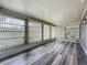 Spacious sunroom featuring wood-look flooring and multiple windows offering abundant natural light at 1156 Capella Dr, Tavares, FL 32778