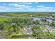 Aerial view showcases the home's location along the water, surrounded by lush greenery and neighborhood at 11750 Watts Ct, Tavares, FL 32778