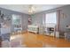 Well-lit Bedroom with wood floors, crib, vanity, and changing table at 11750 Watts Ct, Tavares, FL 32778