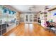 Inviting bonus room with a ceiling fan, hardwood floors, and custom built-ins at 11750 Watts Ct, Tavares, FL 32778