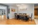 An open dining room features a wooden table, six chairs, and views to the entryway and kitchen at 11750 Watts Ct, Tavares, FL 32778