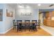 Dining room includes wooden table with six chairs and decor with the word 'Gathering' displayed at 11750 Watts Ct, Tavares, FL 32778