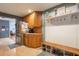Kitchen connects to mud room with hooks, bench, and storage and stainless refrigerator with water and ice dispenser at 11750 Watts Ct, Tavares, FL 32778