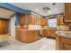 Traditional-style kitchen featuring wood cabinets, tile backsplash, and modern appliances including stainless dishwasher at 11750 Watts Ct, Tavares, FL 32778