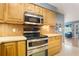 A close up of a kitchen shows stainless steel appliances including a double oven and cooktop at 11750 Watts Ct, Tavares, FL 32778