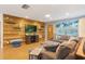 Beautiful living room features a wood paneled accent wall, recessed lighting and an oversized sectional sofa at 11750 Watts Ct, Tavares, FL 32778