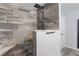 Modern shower featuring gray stone tile with rainfall shower head at 11750 Watts Ct, Tavares, FL 32778