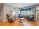 Relaxing sitting area with wood-look floors, comfortable seating, and a bright window creates a serene and inviting space at 11750 Watts Ct, Tavares, FL 32778