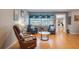 Cozy sitting area with wood-look floors, two armchairs, and an accent table is perfect for relaxation and conversation at 11750 Watts Ct, Tavares, FL 32778
