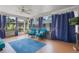 Relaxing sunroom with comfortable seating and bright decorations at 11750 Watts Ct, Tavares, FL 32778