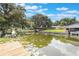 The waterfront features a dock and scenic views of the water and surrounding trees at 11750 Watts Ct, Tavares, FL 32778