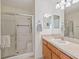 Clean bathroom featuring a shower with glass doors and a light wood vanity at 1199 Mathews Ln, The Villages, FL 32162