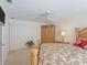 Comfortable bedroom featuring a ceiling fan, neutral carpet and ample closet space at 1199 Mathews Ln, The Villages, FL 32162