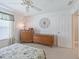 Bedroom featuring a ceiling fan, neutral carpet, and vintage wooden dressers at 1199 Mathews Ln, The Villages, FL 32162