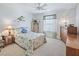 Bedroom featuring a ceiling fan, neutral carpet, and a dresser with decor at 1199 Mathews Ln, The Villages, FL 32162