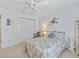 Bedroom featuring a ceiling fan, neutral carpet and a double sliding door closet at 1199 Mathews Ln, The Villages, FL 32162