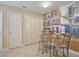 Cozy dining area featuring a glass table, unique decorative mural, and ample storage space at 1199 Mathews Ln, The Villages, FL 32162