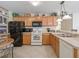 Bright kitchen featuring stainless steel appliances, light wood cabinets and tile flooring at 1199 Mathews Ln, The Villages, FL 32162