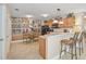 Bright eat-in kitchen featuring a breakfast bar, modern appliances, and unique decorative mural at 1199 Mathews Ln, The Villages, FL 32162