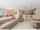 Inviting living space featuring neutral decor, tile flooring, and an open flow to the kitchen and dining areas at 1199 Mathews Ln, The Villages, FL 32162