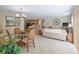 Open-concept living space with tile flooring, flowing into a dining area and kitchen at 1199 Mathews Ln, The Villages, FL 32162
