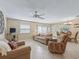 Comfortable living room featuring tile flooring, neutral walls, and a ceiling fan for added comfort at 1199 Mathews Ln, The Villages, FL 32162