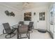 Comfortable enclosed porch featuring a ceiling fan, outdoor seating, and a view of the yard at 1199 Mathews Ln, The Villages, FL 32162