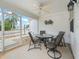 Cozy screened-in porch featuring a ceiling fan and comfortable seating, perfect for relaxing outdoors at 1199 Mathews Ln, The Villages, FL 32162
