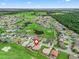 Aerial view of home and community with golf course, mature trees and landscaping at 12198 Se 176Th Loop, Summerfield, FL 34491