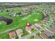 Aerial view of home and community with golf course and mature trees and landscaping at 12198 Se 176Th Loop, Summerfield, FL 34491
