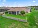 Aerial view of the backyard featuring lush lawn, mature landscaping, and screened-in lanai at 12198 Se 176Th Loop, Summerfield, FL 34491