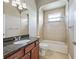 Cozy bathroom with tub-shower combination and granite-topped vanity at 12198 Se 176Th Loop, Summerfield, FL 34491